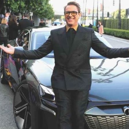 Robert Downey Jr. posing infront of his car